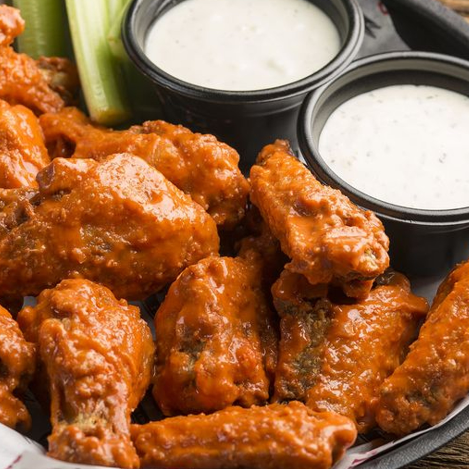 Papa Saverio's Pizzeria's buffalo wings with celery sticks and two cups of ranch dressing.
